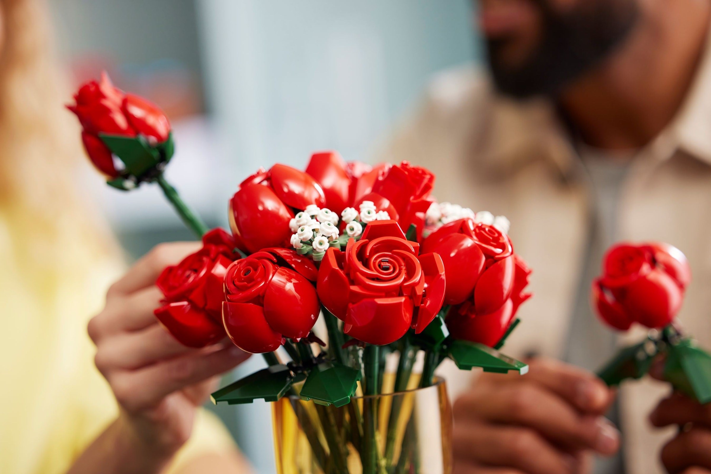 Hands arranging completed bouquet
