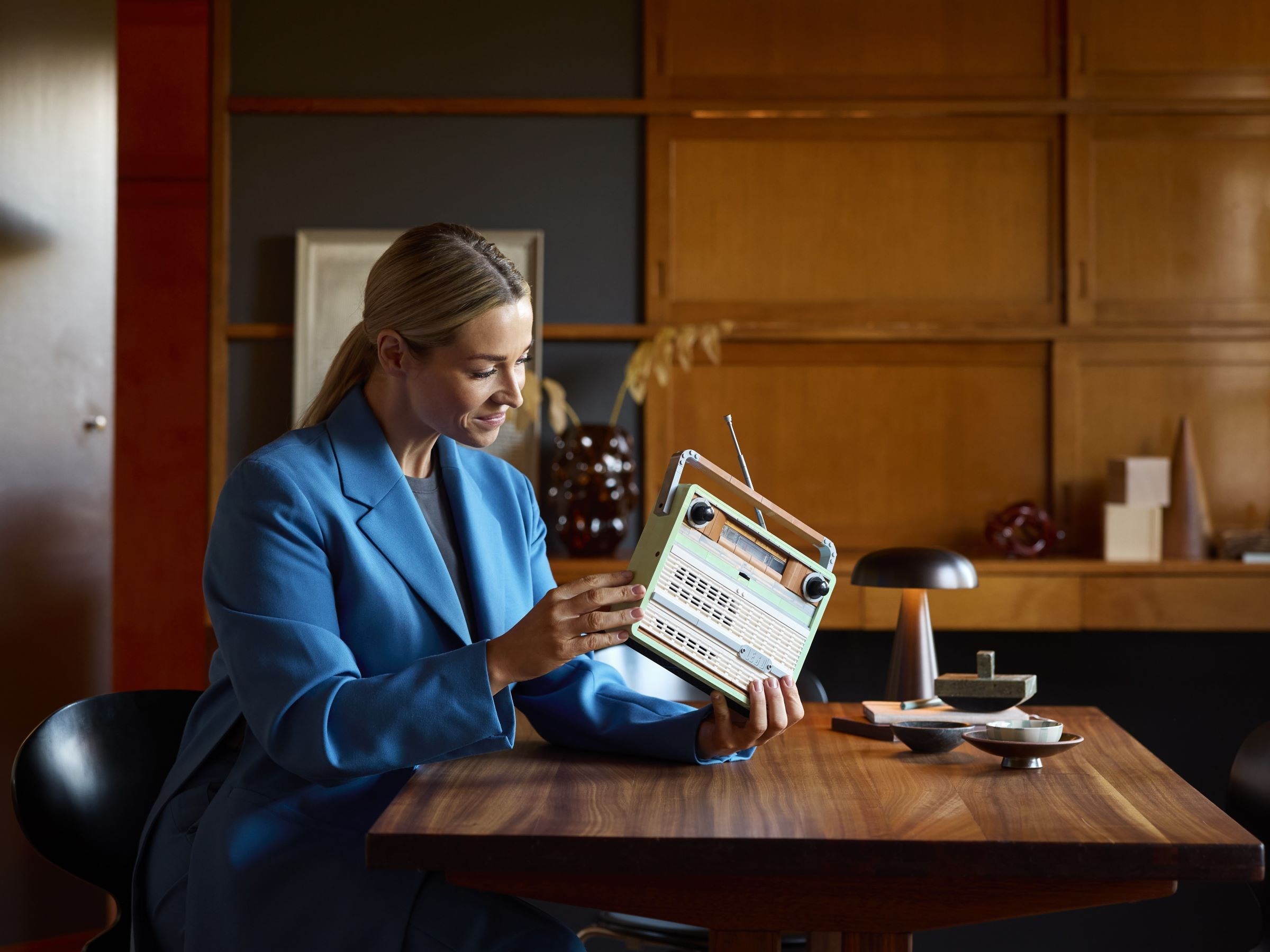 Woman holding radio in lifestyle setting
