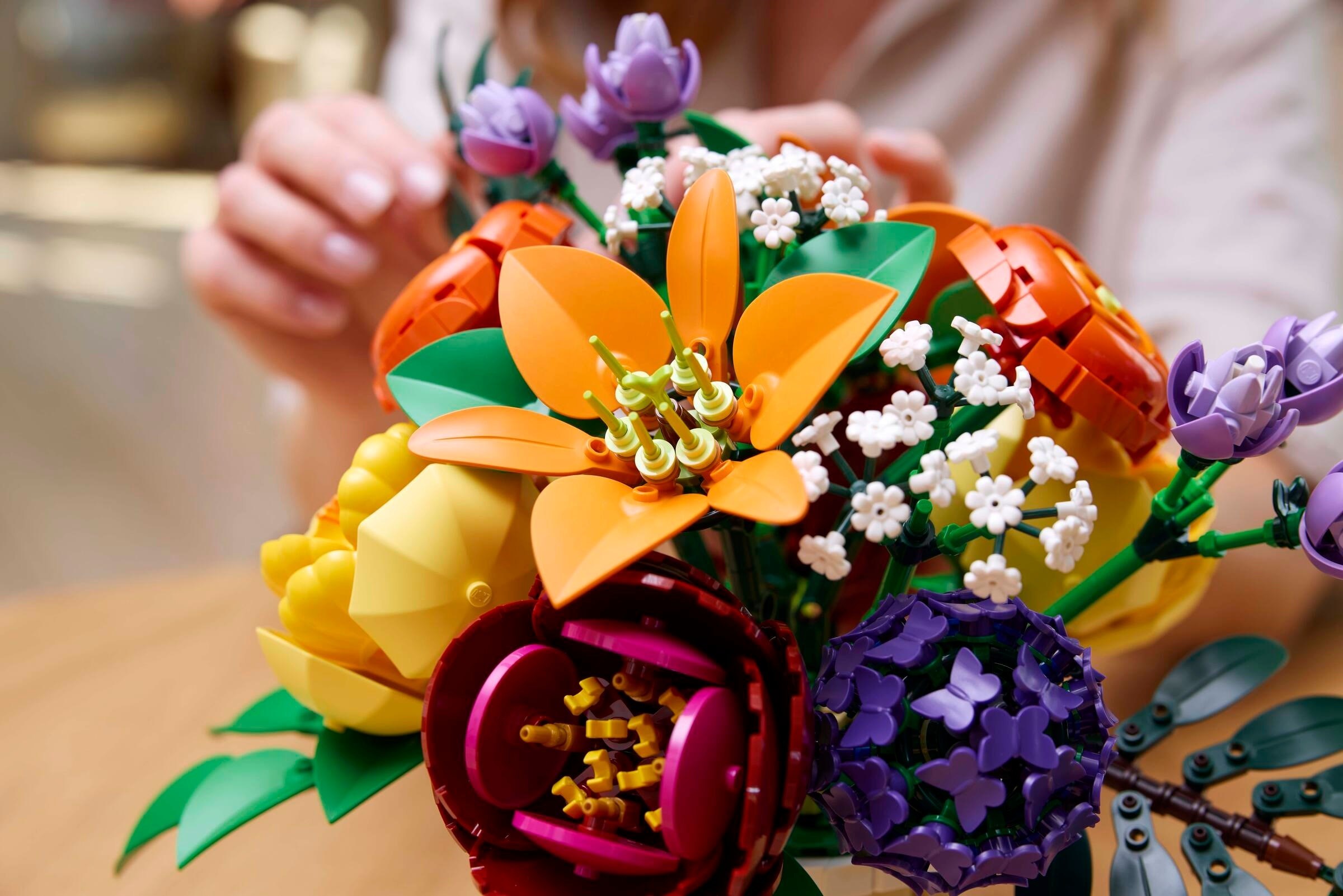 Hands assembling the flower arrangement