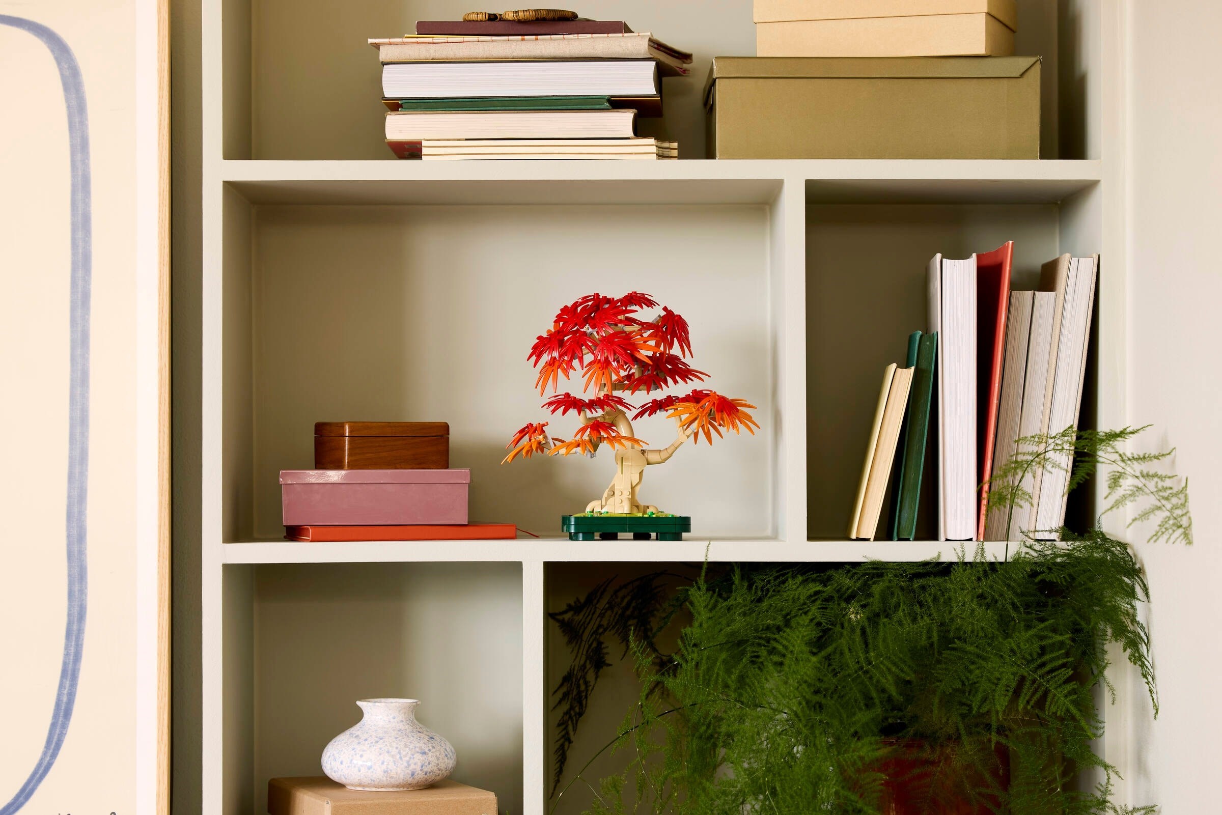 Tree displayed on bookshelf with home decor