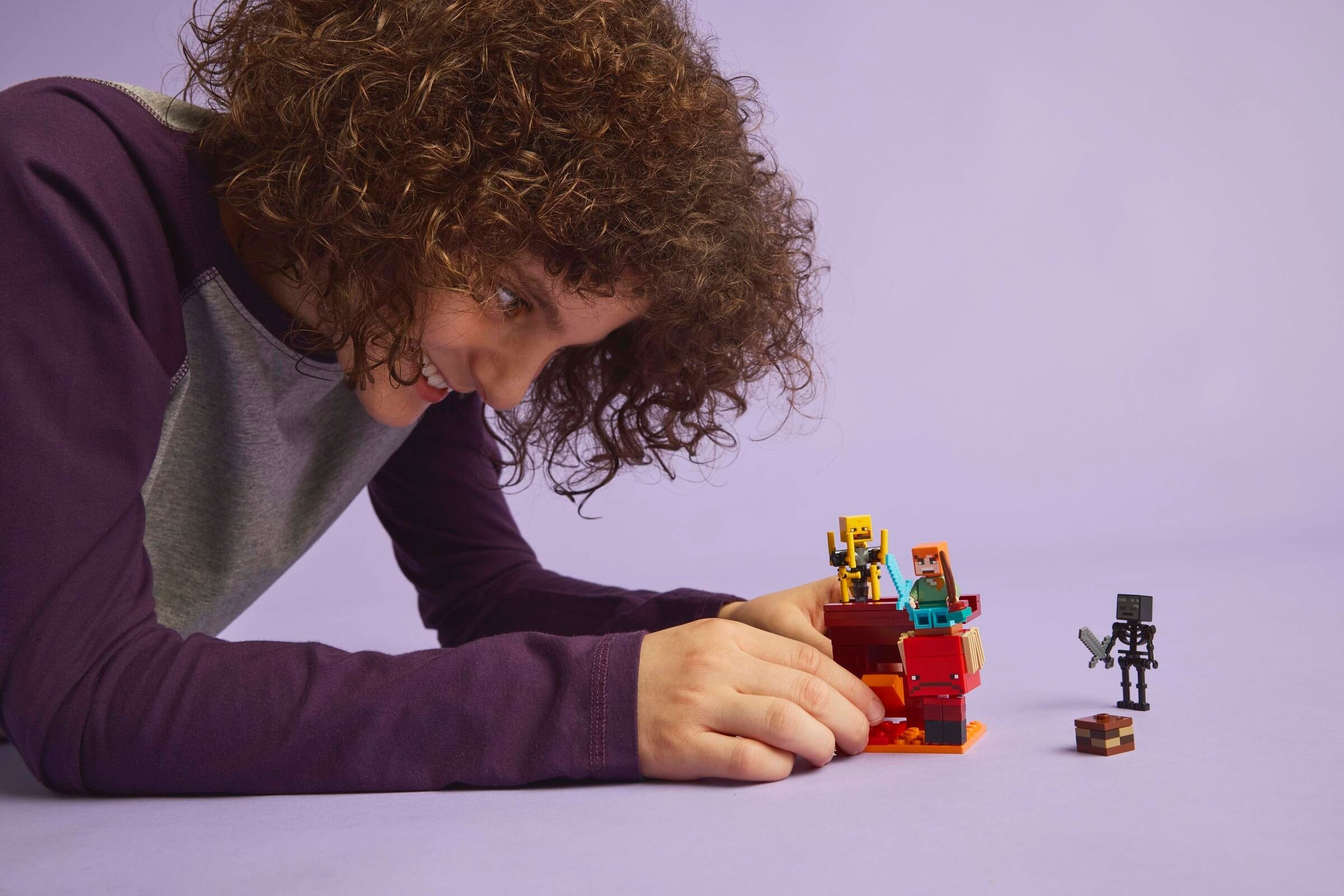 Child playing with LEGO Nether Lava Battle set