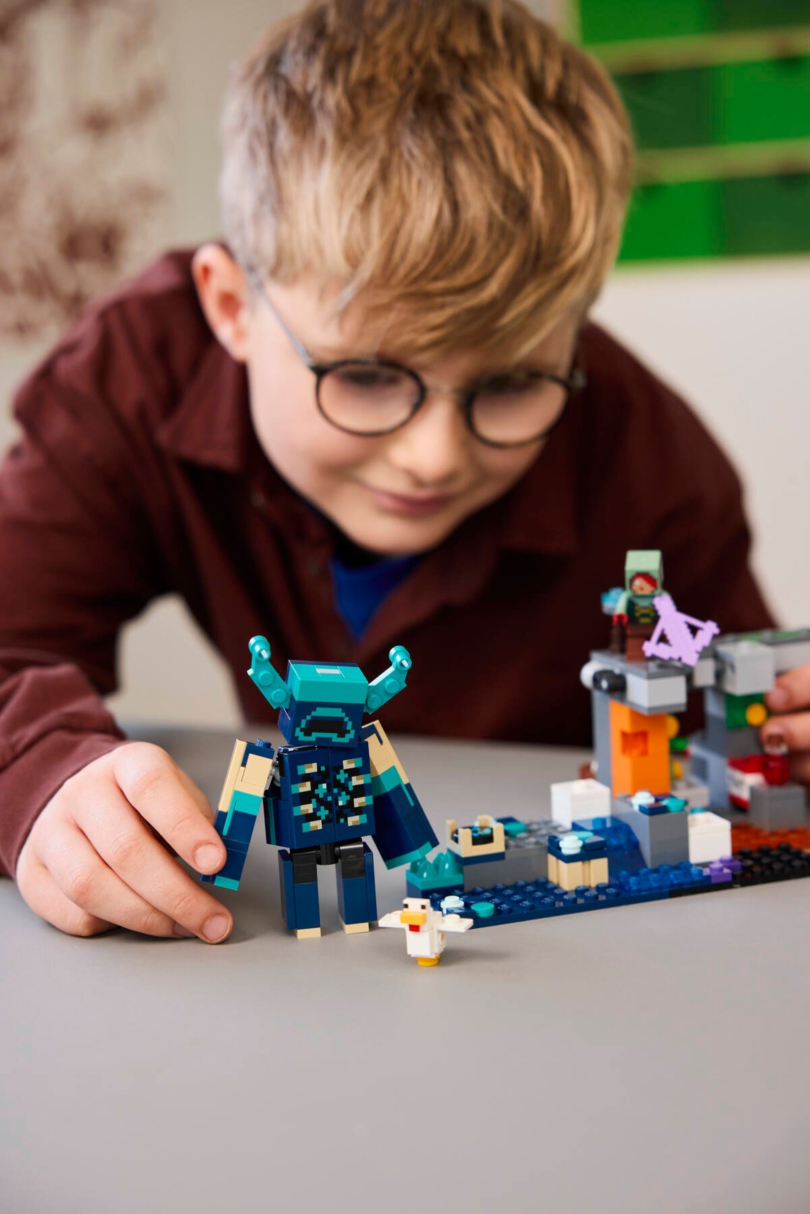 Child playing with detailed Warden figure showing scale and presence