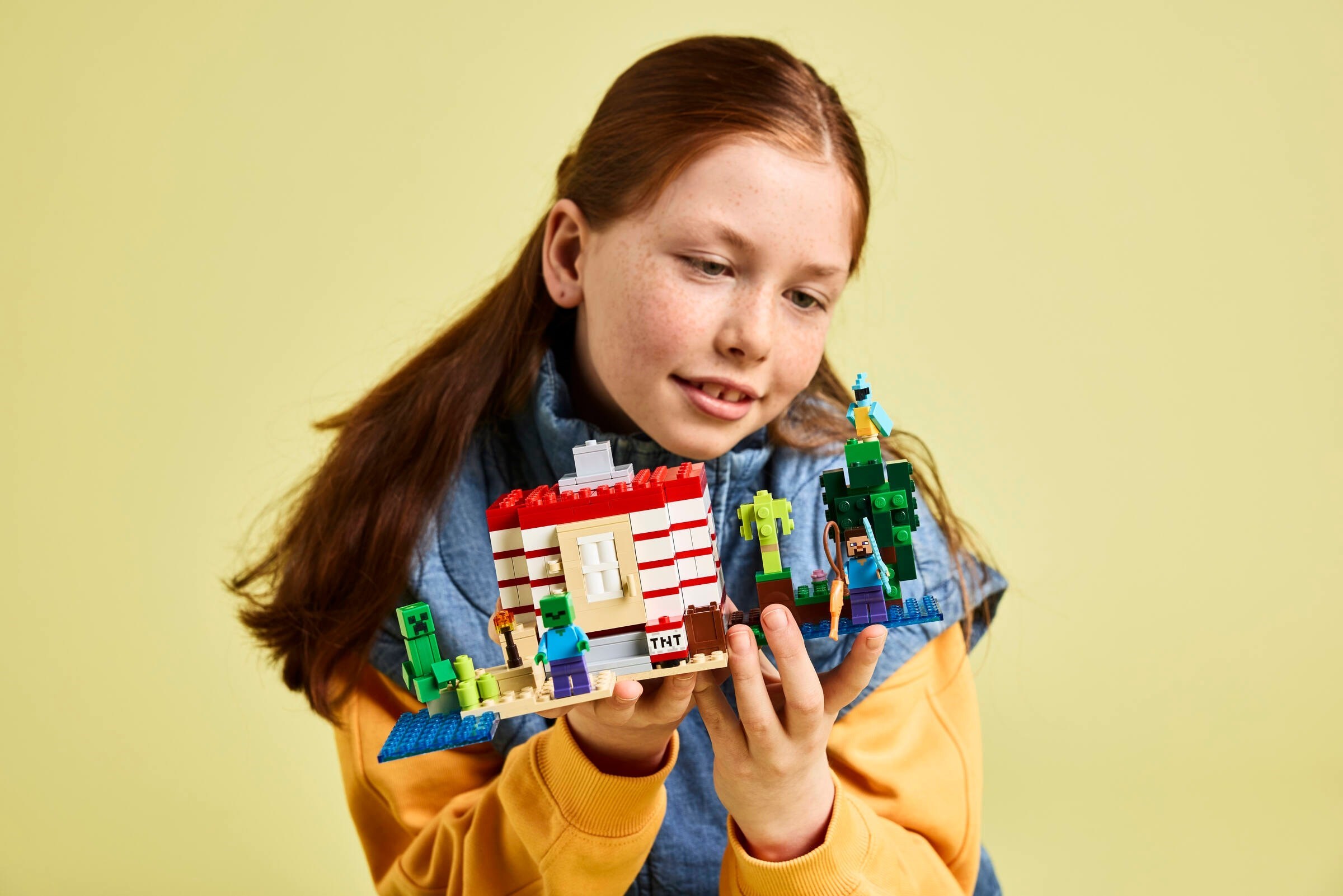 Child demonstrating play features with completed set