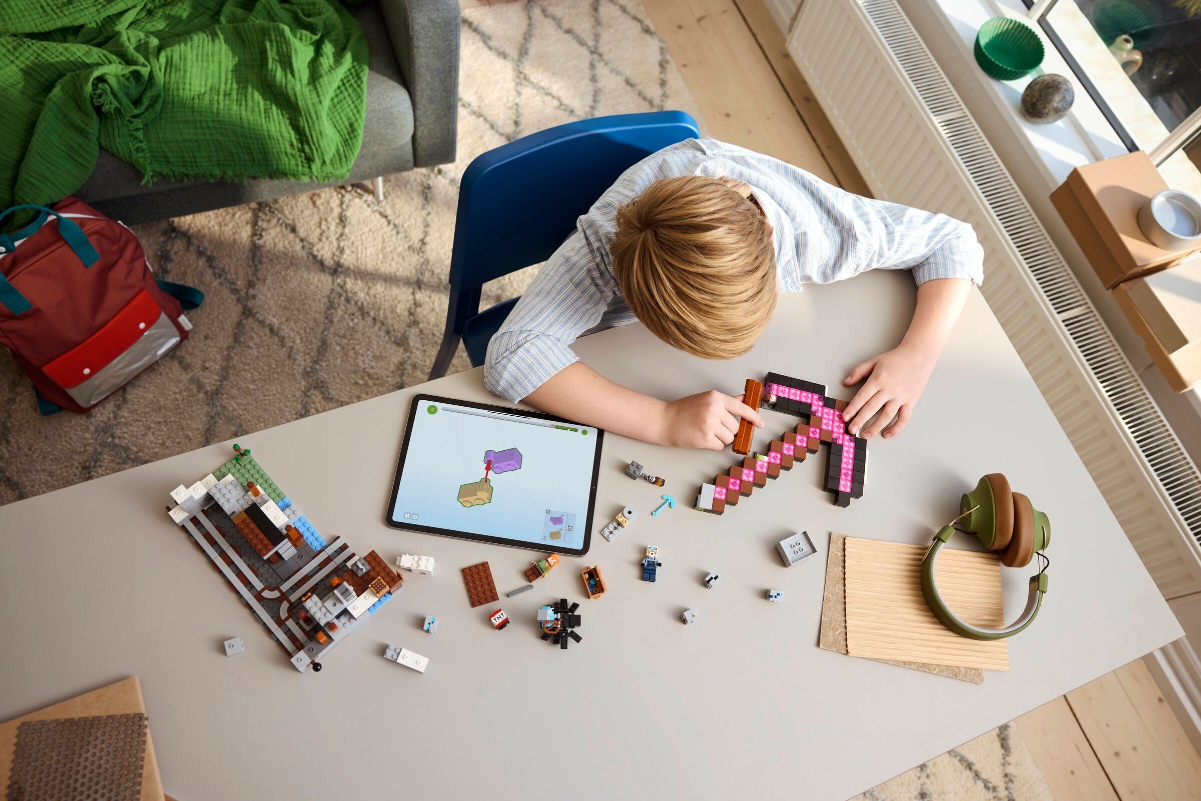 Child building the set with tablet integration and detailed construction
