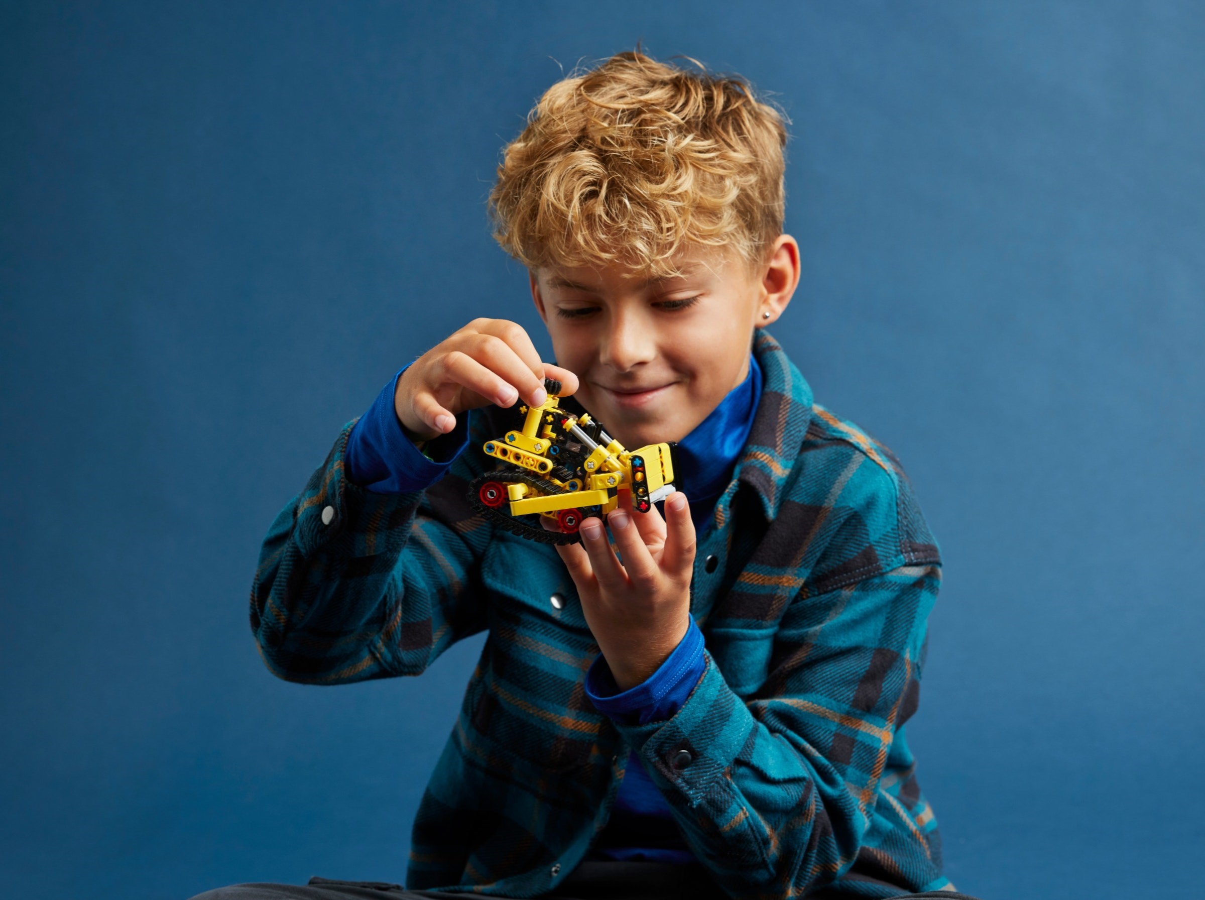 Child playing with bulldozer model