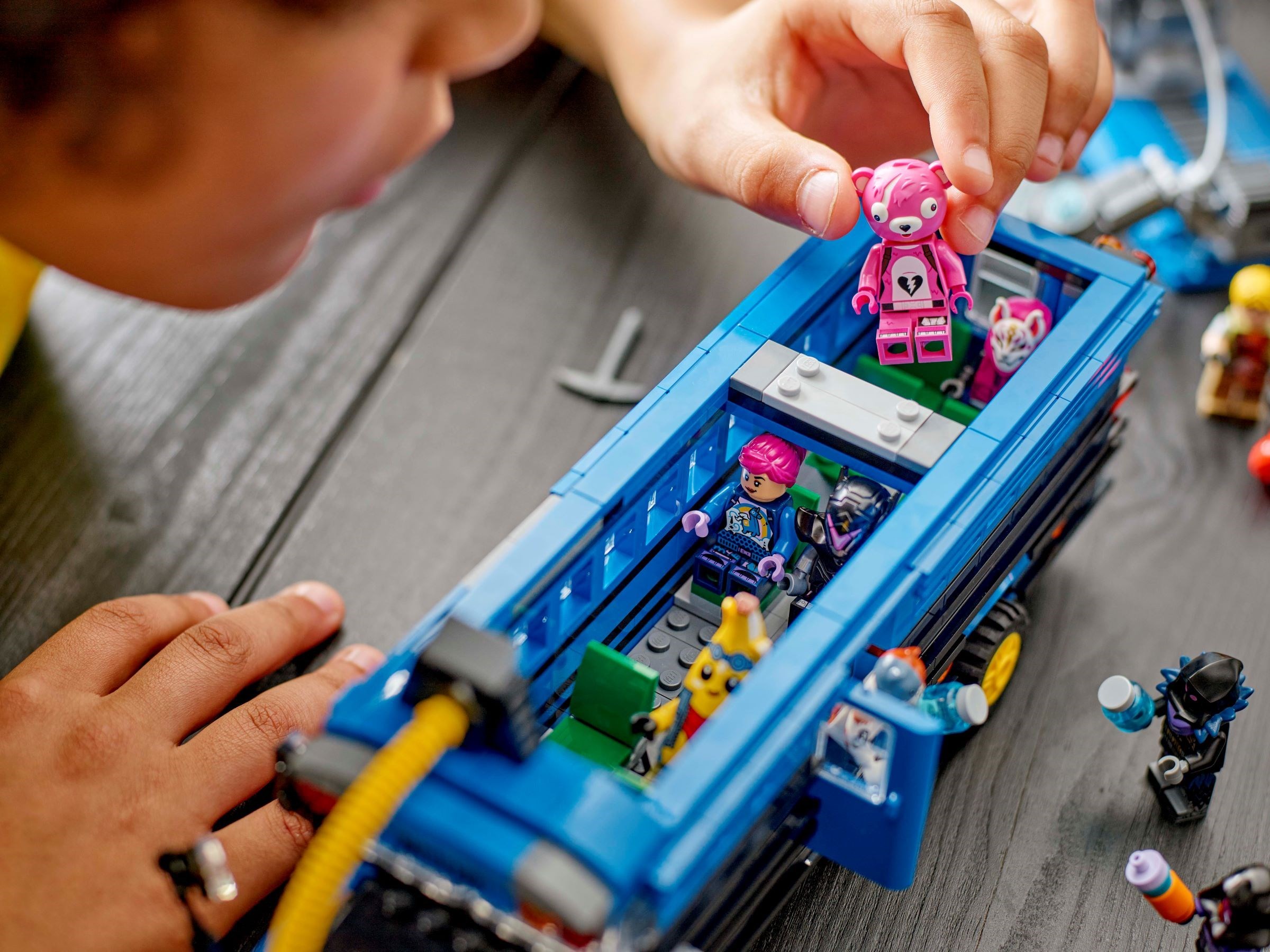 Child playing with minifigures in bus